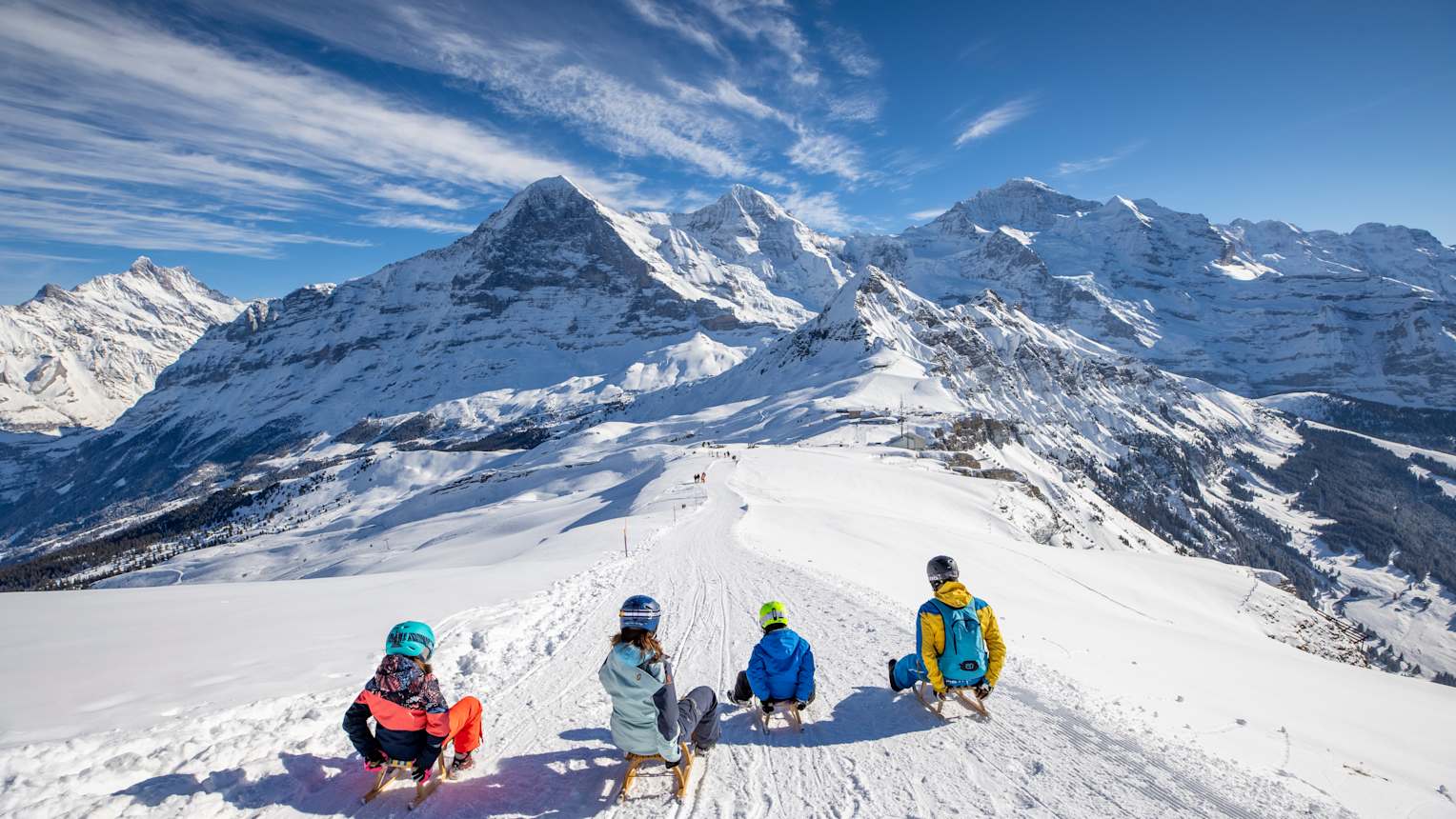 Maennlichen Familie Schlitteln nebeneinander Eiger Moench Jungfrau